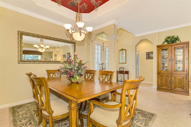 tiled dining space featuring ornamental molding, a raised ceiling, french doors, and a notable chandelier