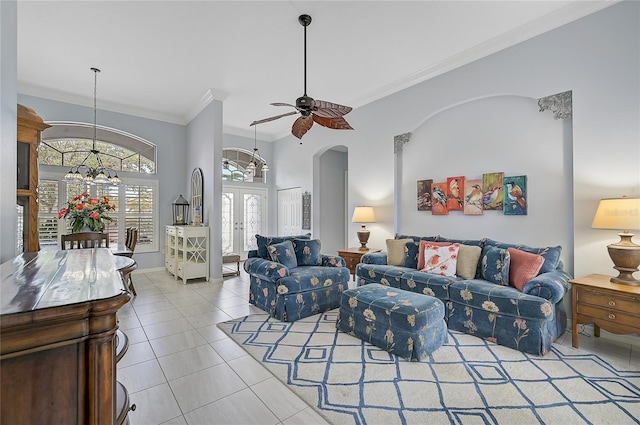 living room featuring french doors, light tile patterned floors, ceiling fan with notable chandelier, and ornamental molding