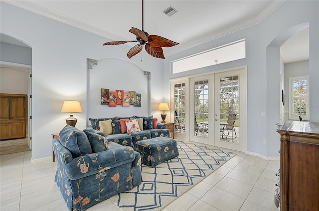 living room featuring ceiling fan, french doors, light tile patterned floors, and ornamental molding