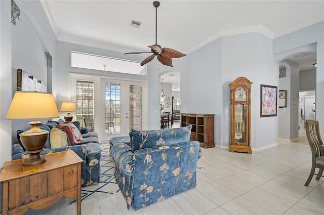 tiled living room featuring french doors, ceiling fan, and ornamental molding