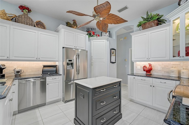 kitchen with white cabinets, appliances with stainless steel finishes, and backsplash