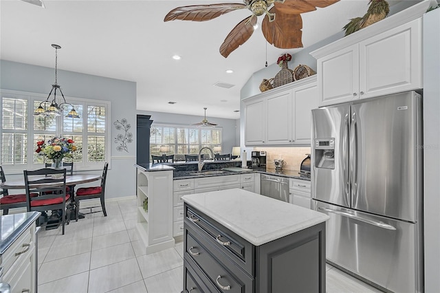 kitchen featuring a center island, stainless steel appliances, and white cabinetry