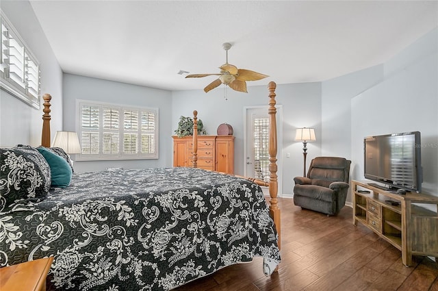 bedroom with dark hardwood / wood-style flooring and ceiling fan