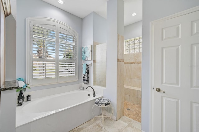 bathroom featuring tile patterned flooring and independent shower and bath