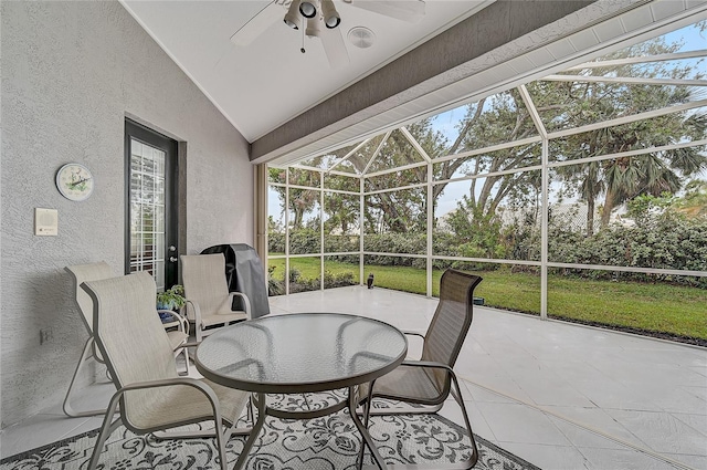 sunroom featuring ceiling fan and vaulted ceiling