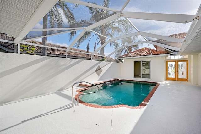 view of swimming pool featuring french doors, a patio, and glass enclosure