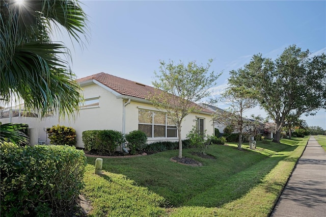 view of side of property with a lawn