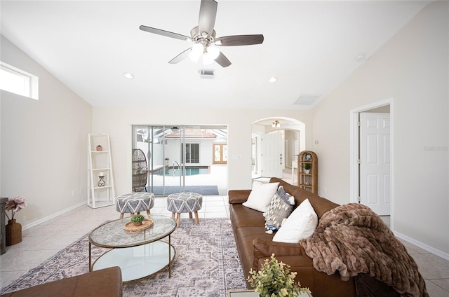 living room with ceiling fan, light tile patterned floors, and vaulted ceiling