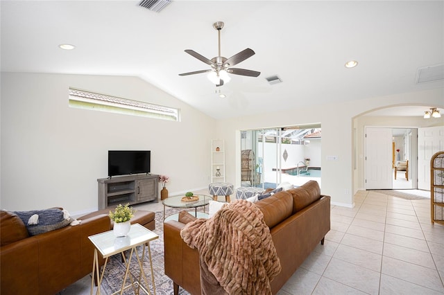 living room featuring ceiling fan, light tile patterned flooring, and vaulted ceiling