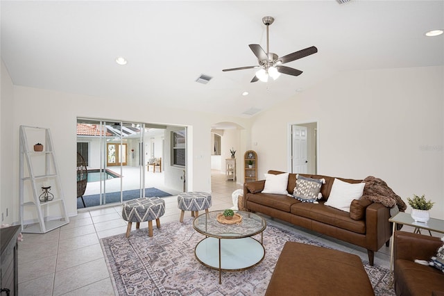 tiled living room featuring ceiling fan and lofted ceiling