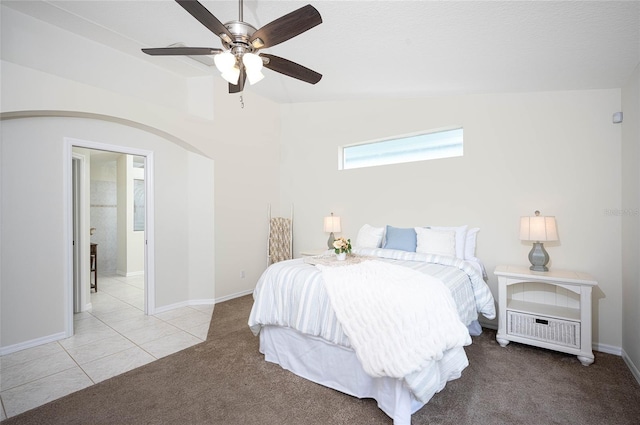 bedroom with ceiling fan, light colored carpet, and lofted ceiling