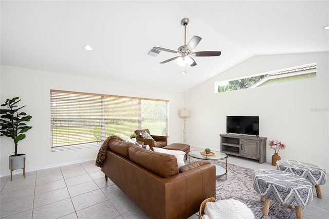 tiled living room with vaulted ceiling, ceiling fan, and a healthy amount of sunlight