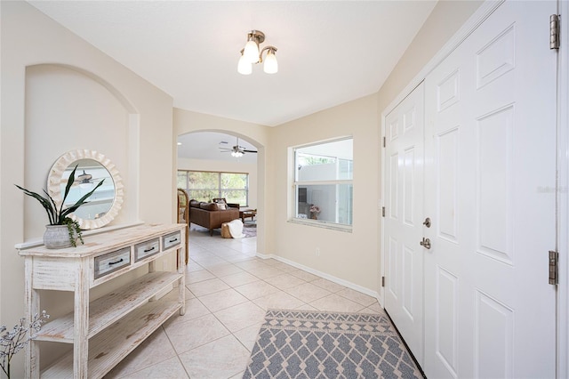 entrance foyer with ceiling fan and light tile patterned floors