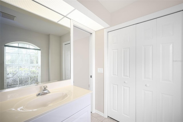 bathroom with tile patterned flooring and vanity