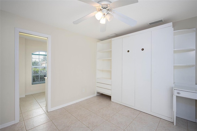 unfurnished bedroom with ceiling fan and light tile patterned flooring