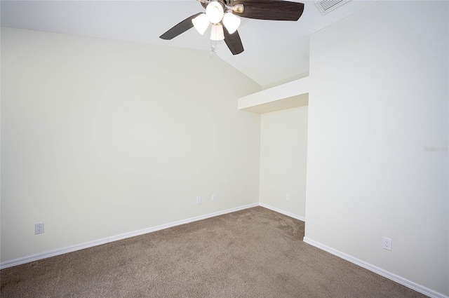 carpeted spare room with vaulted ceiling and ceiling fan