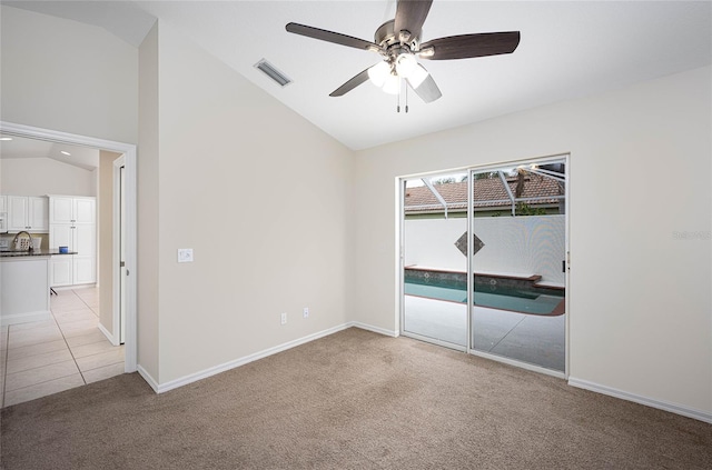 spare room with ceiling fan, sink, lofted ceiling, and light carpet