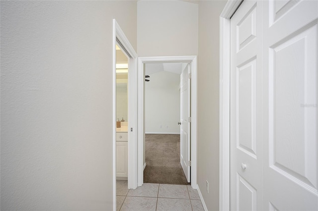 hall featuring light tile patterned floors