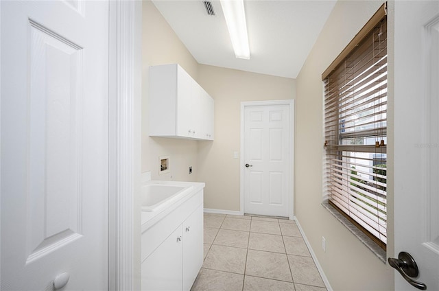 washroom with cabinets, light tile patterned floors, hookup for a washing machine, and hookup for an electric dryer