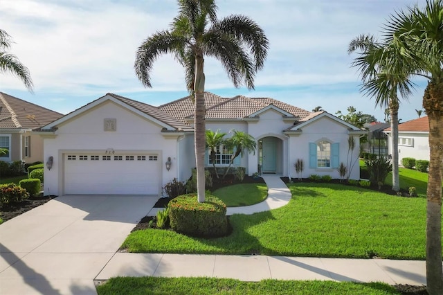 view of front of house with a garage and a front lawn