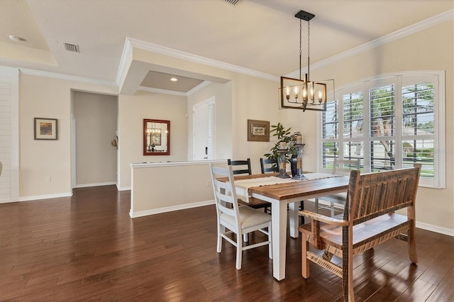 dining space with a chandelier, dark hardwood / wood-style flooring, and crown molding