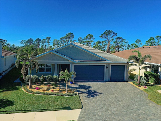 view of front of property with a garage and a front lawn