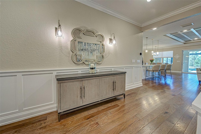 interior space featuring hardwood / wood-style flooring and ornamental molding