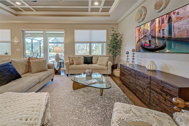 living room featuring coffered ceiling, crown molding, and hardwood / wood-style flooring