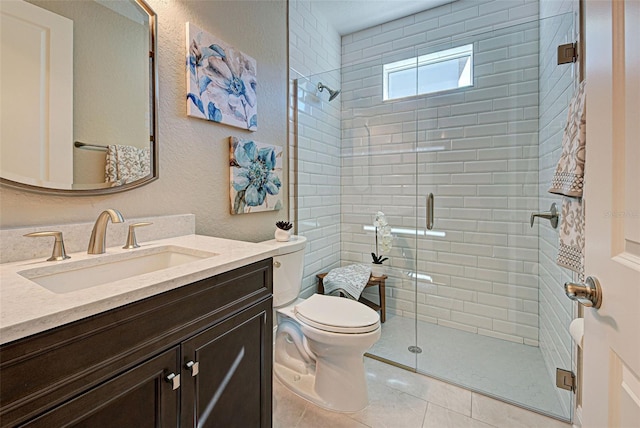 bathroom with tile patterned flooring, vanity, an enclosed shower, and toilet