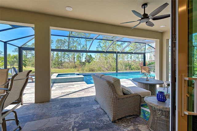 view of patio / terrace featuring a swimming pool with hot tub, a lanai, and ceiling fan