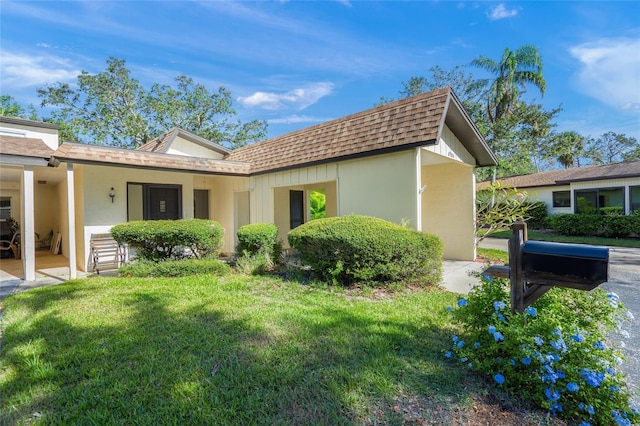 view of side of property with a lawn