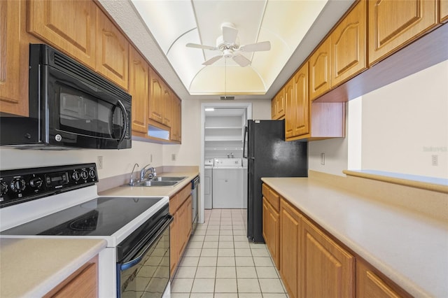 kitchen featuring ceiling fan, sink, washer and dryer, black appliances, and light tile patterned flooring