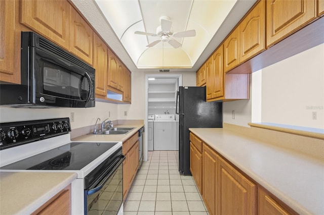 6906 Woodwind Dr Unit 12, Sarasota, FL 34231 - kitchen with black appliances, a sink, independent washer and dryer, ceiling fan, and light tile patterned floors