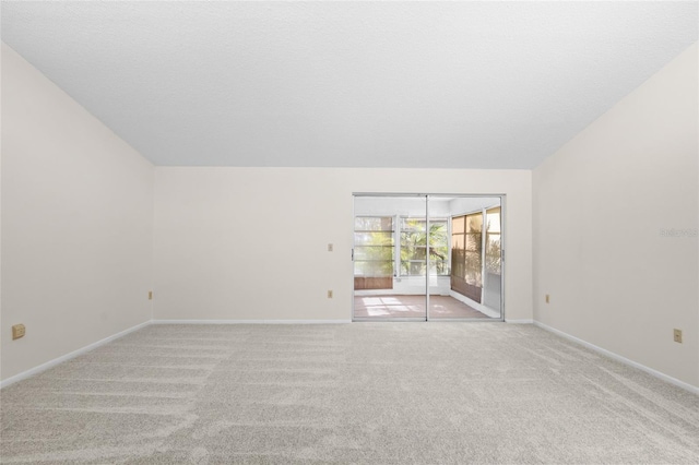 empty room featuring light colored carpet and a textured ceiling