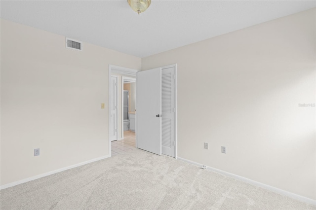 6906 Woodwind Dr Unit 12, Sarasota, FL 34231 - spare room featuring light colored carpet and baseboards
