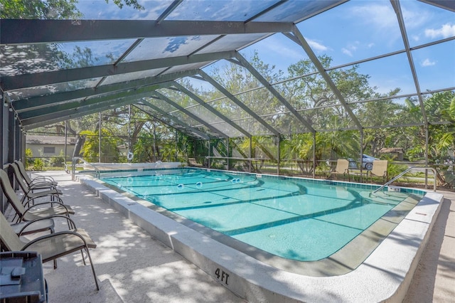 view of swimming pool with a patio and a lanai