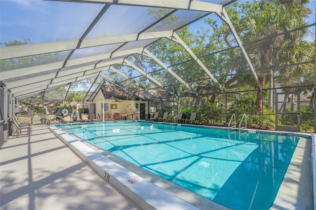 view of swimming pool with a lanai and a patio