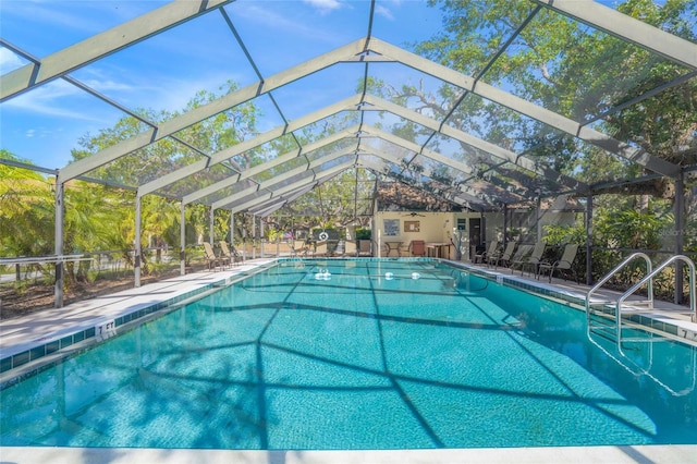 view of pool with glass enclosure