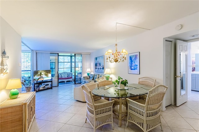 dining room featuring a notable chandelier, expansive windows, and light tile patterned floors