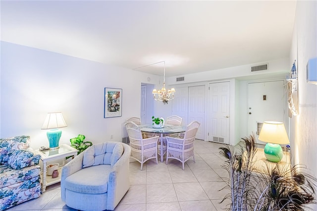 dining room featuring light tile patterned flooring and an inviting chandelier