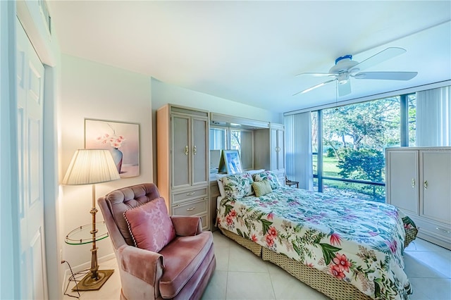 bedroom featuring light tile patterned flooring, multiple windows, and ceiling fan