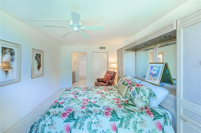 tiled bedroom featuring ensuite bath and ceiling fan