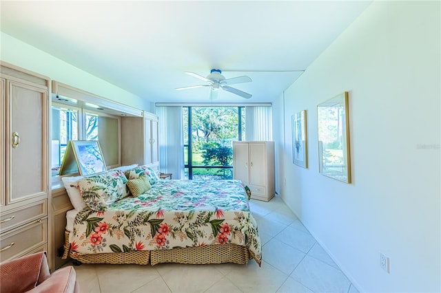 tiled bedroom with ceiling fan and multiple windows