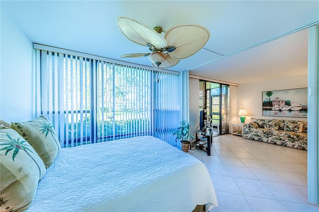 bedroom with ceiling fan and light tile patterned floors