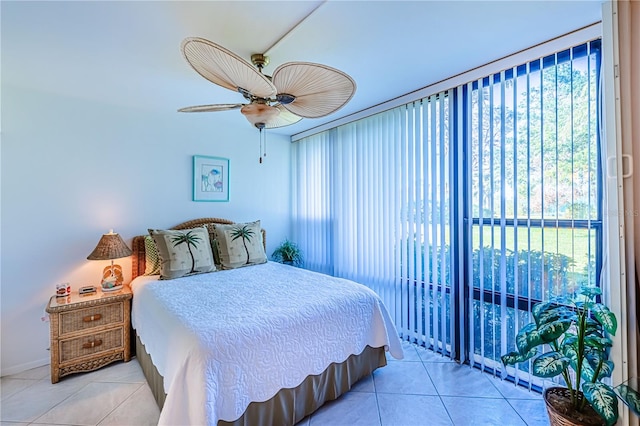 bedroom featuring multiple windows, ceiling fan, and light tile patterned flooring