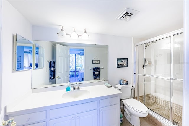 612 Bird Bay Dr S Unit 114, Venice, FL 34285 - bathroom with toilet, a stall shower, vanity, and tile patterned flooring