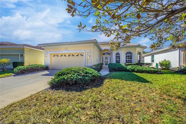 view of front of house featuring a front yard and a garage