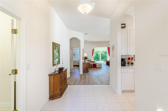 hall with light tile patterned flooring