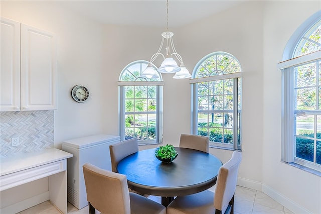 dining room featuring a chandelier and light tile patterned flooring