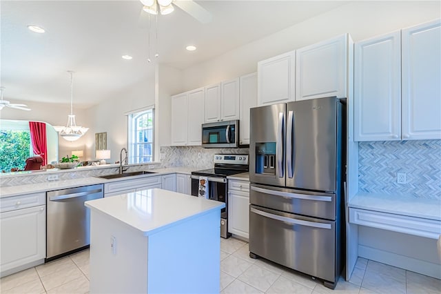 kitchen featuring a healthy amount of sunlight, sink, white cabinets, and stainless steel appliances